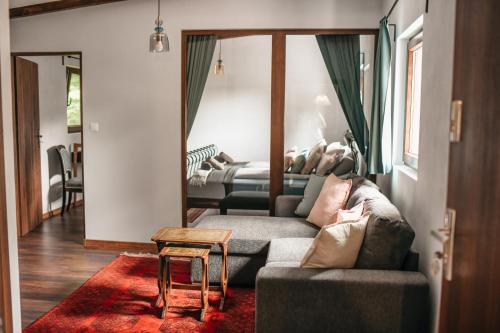 a living room with a couch and a table at Uroczysko Oleśnica in Chodzież