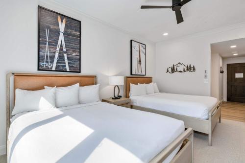 two beds in a room with white walls at The Charter at Beaver Creek E135 in Beaver Creek