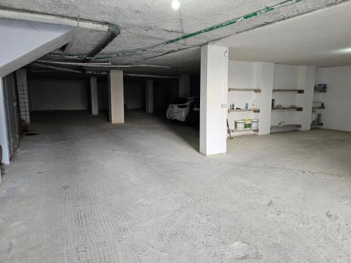 an empty garage with a car parked in it at Eagle’s Nest in Shkodër