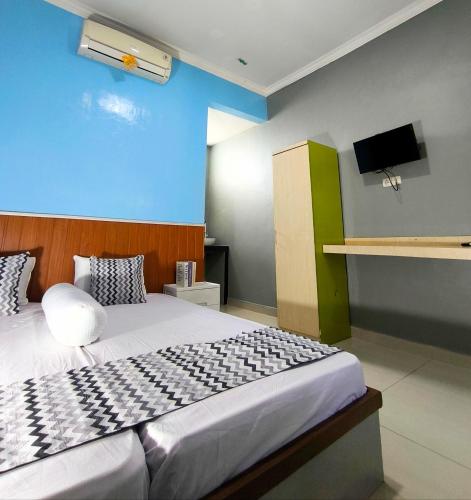 Katil atau katil-katil dalam bilik di Pekalongan StayInn