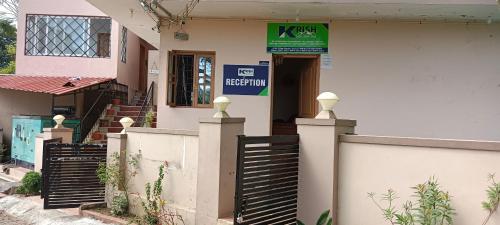 a building with a gate and a sign on it at Tn27callingkrishholiday in Yercaud