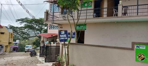 a building with signs on the side of it at Tn27callingkrishholiday in Yercaud
