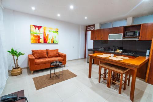 a kitchen and living room with a table and a couch at Suites House in Cali