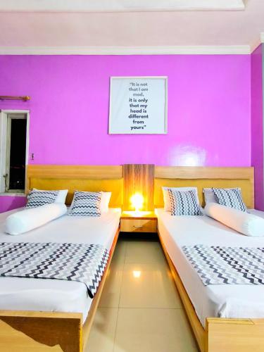Katil atau katil-katil dalam bilik di Pekalongan StayInn