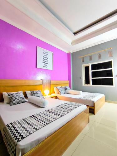 Katil atau katil-katil dalam bilik di Pekalongan StayInn