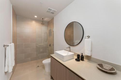 a bathroom with a sink and a mirror at Costa Elena at Naumi, Ocean Views & Beach Club in Sardinal