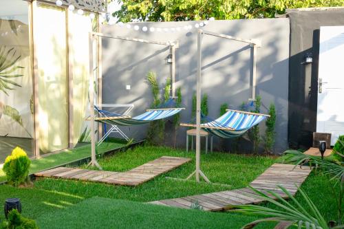 two chairs sitting on the grass in a yard at Maison à Skhirat Jacuzzi, jardin & proche plage in Skhirat