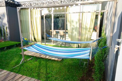 a hammock on the side of a house at Maison à Skhirat Jacuzzi, jardin & proche plage in Skhirat