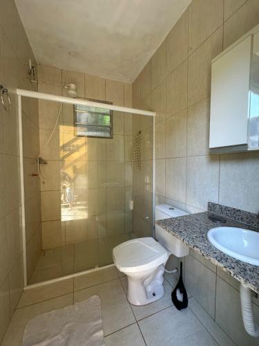 a bathroom with a toilet and a sink at Caiçara's house in Praia de Araçatiba