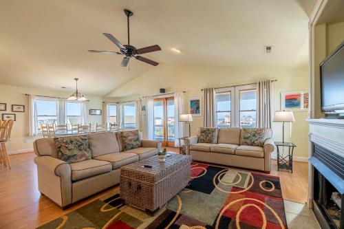 a living room with two couches and a tv at Funtiki in Whalebone