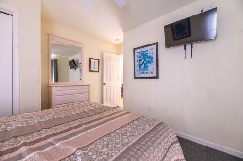 a bedroom with a bed and a tv on the wall at Funtiki in Whalebone