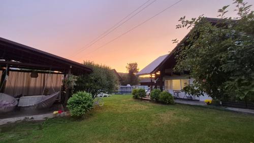 a view of a yard with a house and a yard at Захарова Оселя БАСЕЙН на території є Чан - Джакузі in Slavske