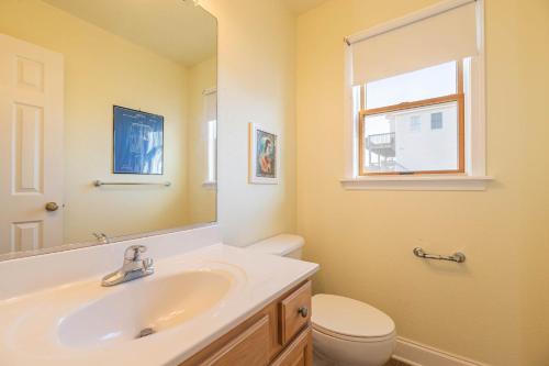a bathroom with a sink and a toilet and a mirror at Funtiki in Whalebone