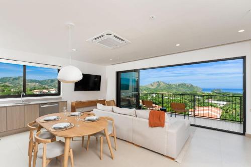 a living room with a couch and a table at Sol Pacífico at Naumi, Ocean Views & Beach Club in Sardinal