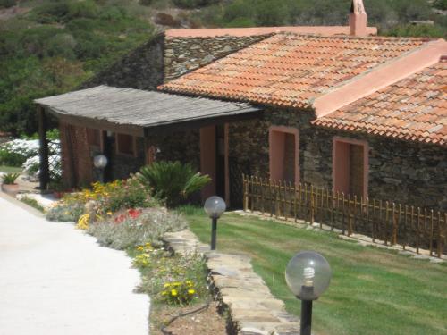 a stone house with a garden in front of it at La Chintana in Palmadula