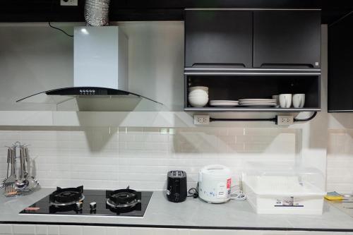a kitchen with a stove and a counter top at Parsons Place in Chiang Mai! in Chiang Mai
