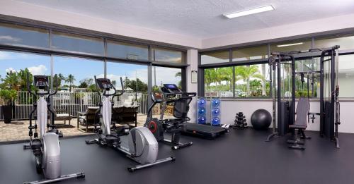 a gym with several treadmills and elliptical machines at Ramada by Wyndham Sarasota Waterfront in Sarasota