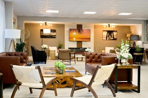 a lobby with a waiting room with couches and chairs at Ramada by Wyndham Sarasota Waterfront in Sarasota