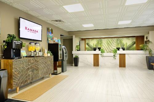 a lobby with a pharmacy sign on the wall at Ramada by Wyndham Sarasota Waterfront in Sarasota