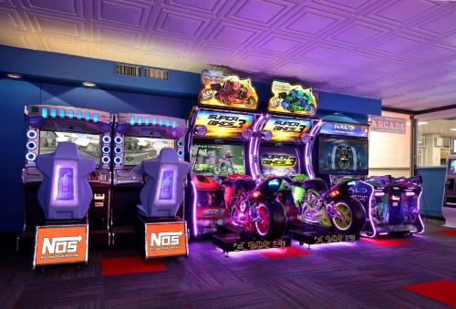 a group of video games in a room with arcade machines at Ramada by Wyndham Sarasota Waterfront in Sarasota