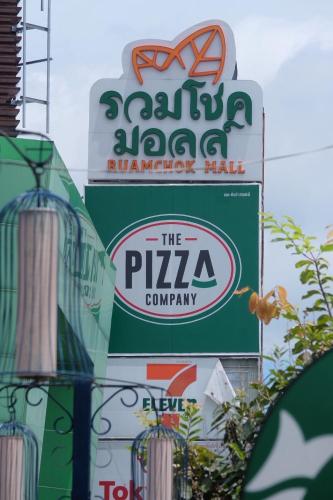 a sign for the pizza company and a sign for a restaurant at Parsons Place in Chiang Mai! in Chiang Mai