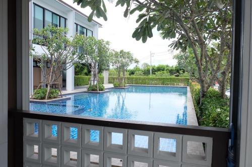 a view of a swimming pool through a window at Parsons Place in Chiang Mai! in Chiang Mai