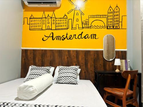 a bedroom with a bed and a yellow wall at Semarang CoStay in Alastuwo