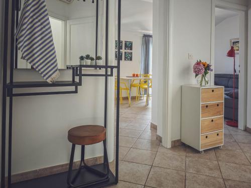a room with a stool and a room with a table at Apartments Maestral in Trpanj