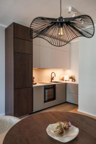 a kitchen with a table and a ceiling at Skyline Suite - Danube-View Balcony & Pool in Vienna