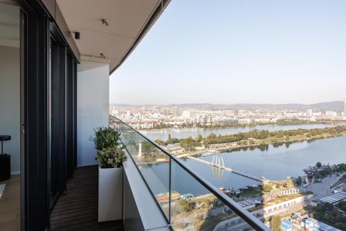 a balcony with a view of a river at Skyline Suite - Danube-View Balcony & Pool in Vienna