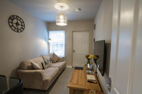 a living room with a couch and a tv at Relaxing Town Centre House - Perfect for Exploring in Shrewsbury