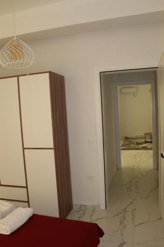 a room with a bed and a mirror at Lunis Dobra Voda in Dobra Voda