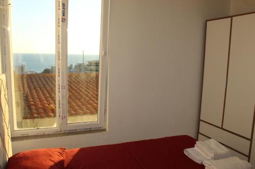 a bedroom with a window with a view of a roof at Lunis Dobra Voda in Dobra Voda