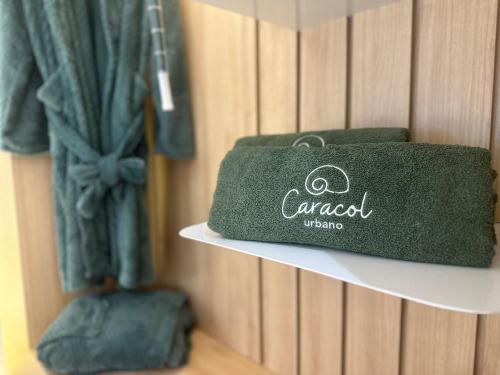 a green towel is sitting on a shelf at Apartamentos Exclusivos no Edifício City House in Barreiras