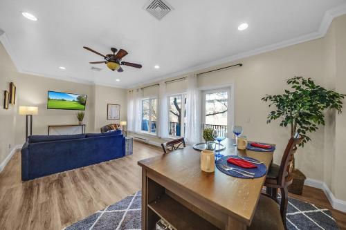 a living room with a table and a blue couch at Loft Apt with Balcony in the Heart of Kennett Square in Kennett Square