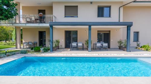 a house with a swimming pool in front of a house at Alfredo Residence in Albiano dʼIvrea