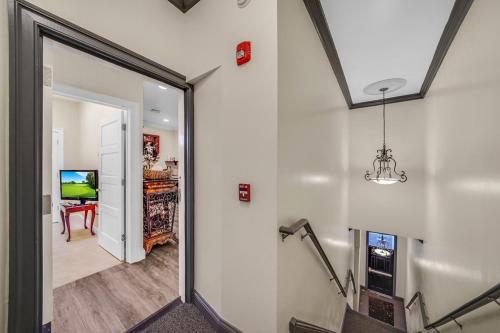 a hallway with a door leading to a living room at Loft Apt with Balcony in the Heart of Kennett Square in Kennett Square