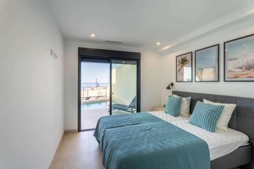 a bedroom with a bed and a view of a pool at House with Private Spa and Pool, with access to Sauna and Gym in Torrox Costa