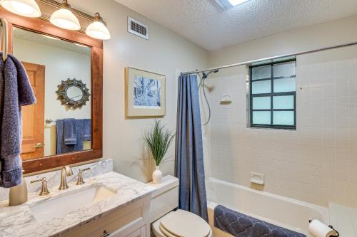 a bathroom with a sink and a toilet and a tub at Little Lake George Hideaway with Furnished Boathouse in Welaka