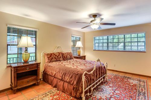 a bedroom with a bed and a ceiling fan at Little Lake George Hideaway with Furnished Boathouse in Welaka
