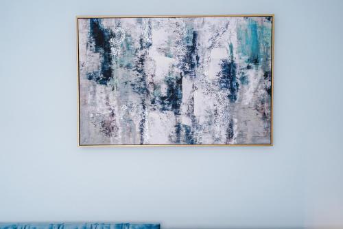 a painting in a frame on a wall at 3BR House By Eason Stays Short Term Rental Wythenshawe Near Manchester Airport with Free Parking in Wythenshawe