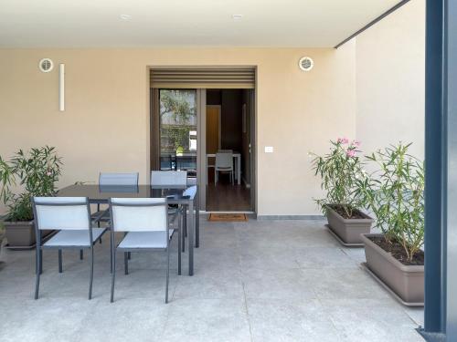a dining room with a table and chairs and plants at Alfredo Residence in Albiano dʼIvrea