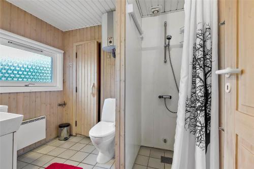a bathroom with a toilet and a shower curtain at BV195-Vejers-Strand-Jafdalvej-51 in Vejers Strand