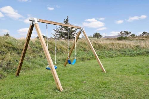 two swings in a field with a grassy field at BV195-Vejers-Strand-Jafdalvej-51 in Vejers Strand