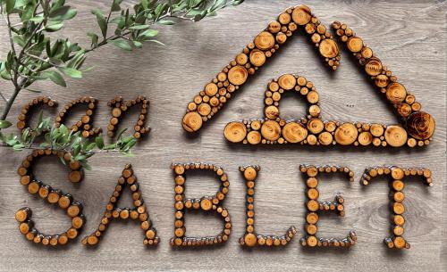 a word written in wood beads on a table at Can Sablet in Horta de San Joan