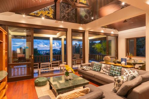 a living room with a couch and a table at Villa Melita 5 bedrooms, hillside location with pool and seaview in Kata Beach