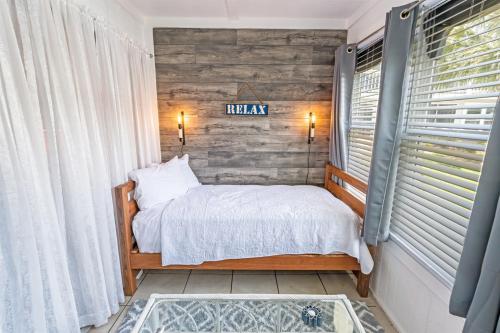 a bedroom with a bed and a sign on the wall at NEW! Large 1BR at The Golf Colony at Baytree, Pool in Stephens Crossroads