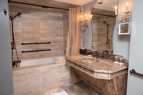 a bathroom with a large sink and a shower at Grand Bohemian Lodge Asheville, Autograph Collection in Asheville