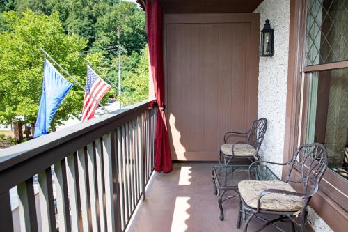 a balcony with chairs and flags on a house at Grand Bohemian Lodge Asheville, Autograph Collection in Asheville