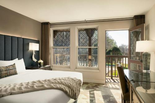 a bedroom with a bed and a large window at Grand Bohemian Lodge Asheville, Autograph Collection in Asheville